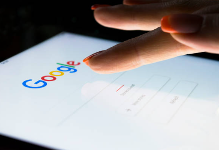 a woman's finger tapping Google search page on a tablet
