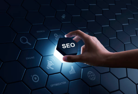 a hand lifting up a hexagon with the word saying SEO