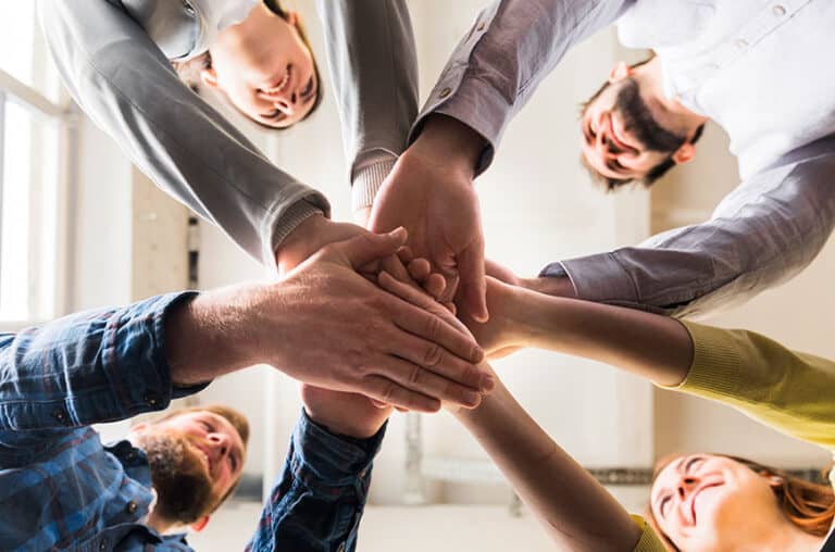 4 people doing a hand shake