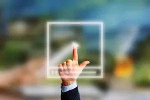index finger touching a play button on a video